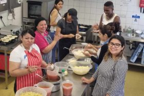 Participants in the well-being morning for people seeking asylum are cooking at Frimhurst Family House