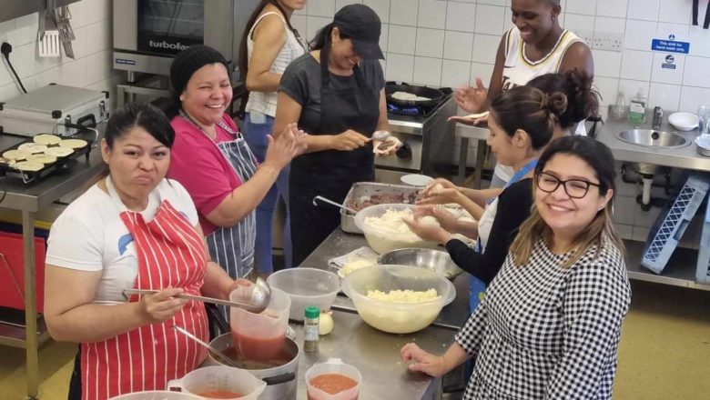 Participants in the well-being morning for people seeking asylum are cooking at Frimhurst Family House