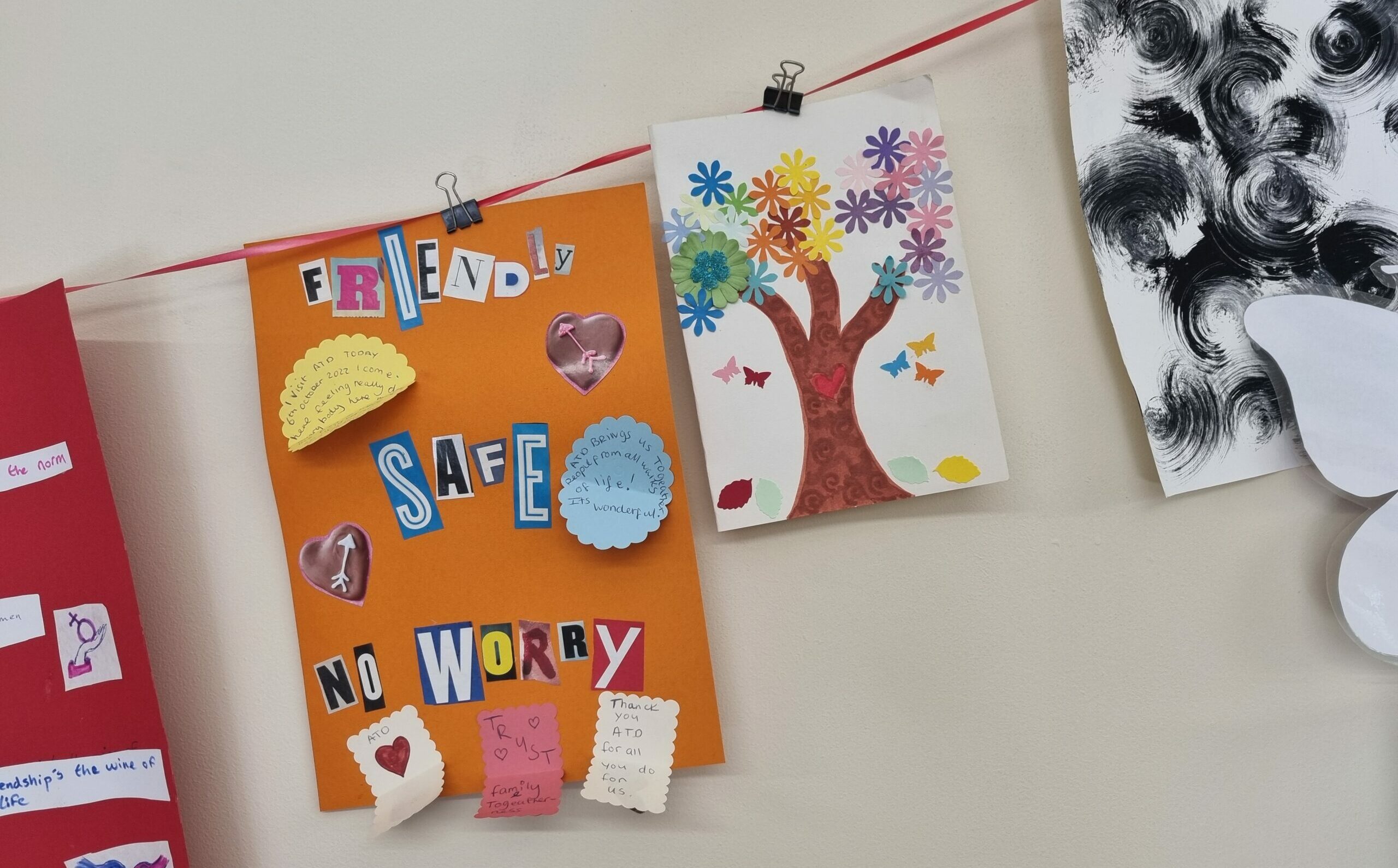 A paper collage made by someone who came to ATD for a well-being activity reads: "Friendly, safe; no worry"